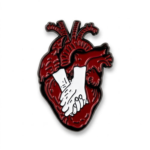 Anatomical red heart enamel metal brooch with white hands holding each other